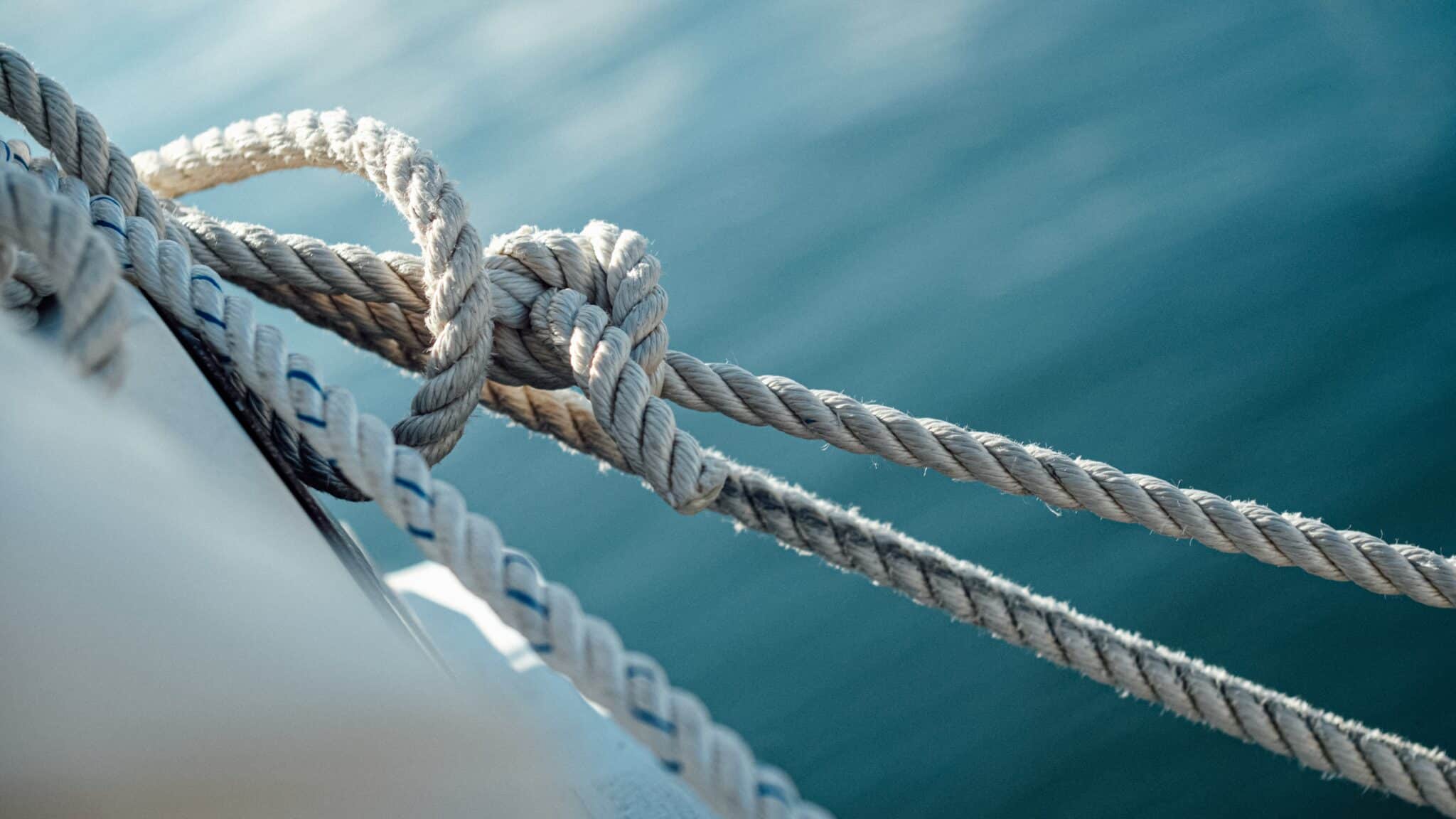 Closeup of the ship wires with the sea on the background under sunlight